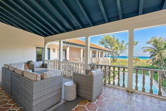 view of patio with a water view and an outdoor living space