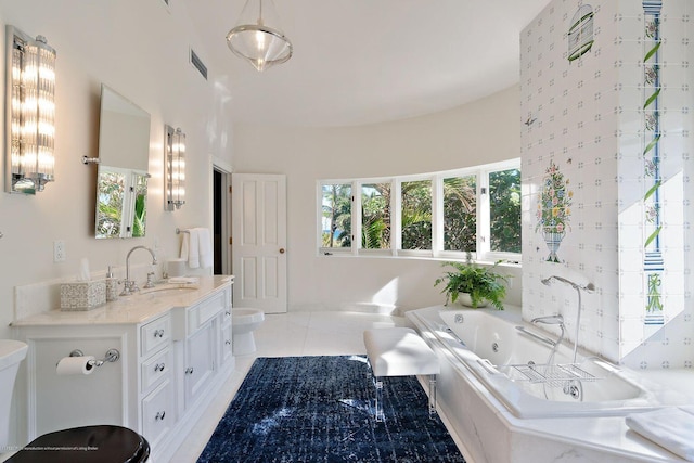 bathroom with vanity, a tub, tile patterned floors, and toilet