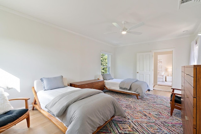 bedroom featuring crown molding, ceiling fan, and light hardwood / wood-style flooring