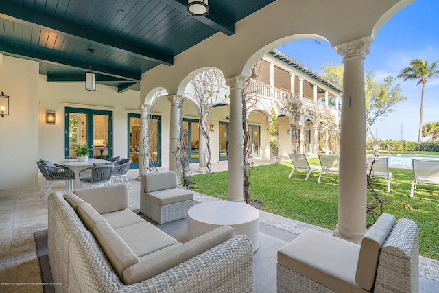 view of patio / terrace featuring an outdoor hangout area, french doors, ceiling fan, and a water view