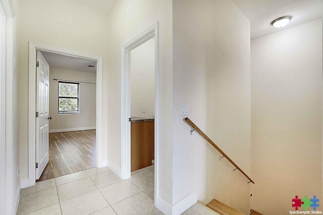 hall featuring light tile patterned floors