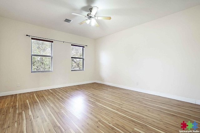 empty room featuring hardwood / wood-style floors and ceiling fan