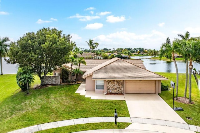 single story home with a garage, a water view, and a front lawn