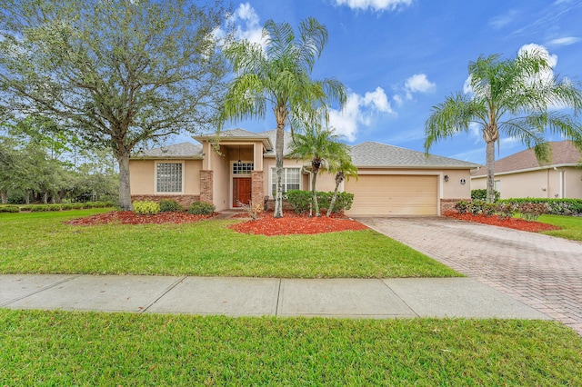 view of front of home featuring a garage, decorative driveway, a front lawn, and stucco siding