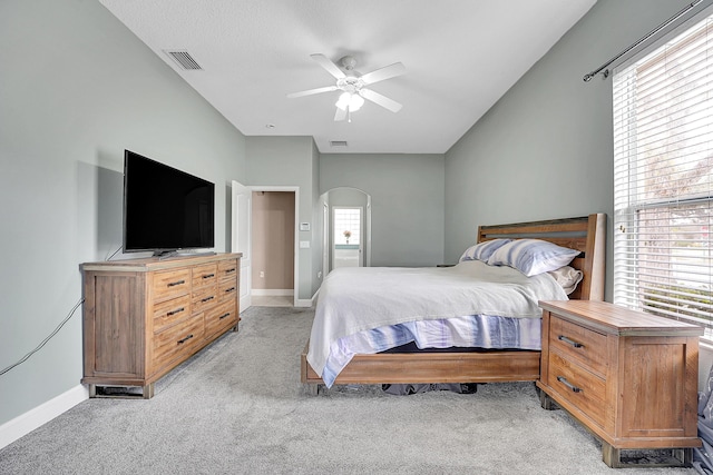 bedroom featuring multiple windows, visible vents, and light colored carpet