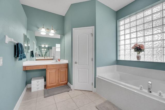 full bath with baseboards, a garden tub, vanity, and tile patterned floors