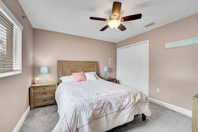 bedroom featuring baseboards, a closet, visible vents, and carpet flooring