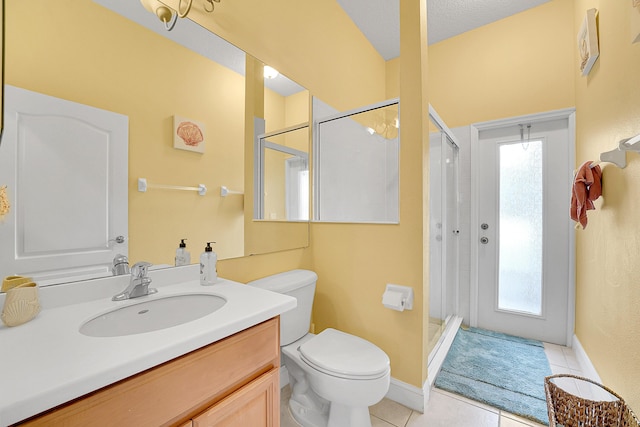 full bathroom featuring toilet, a shower stall, vanity, and tile patterned floors