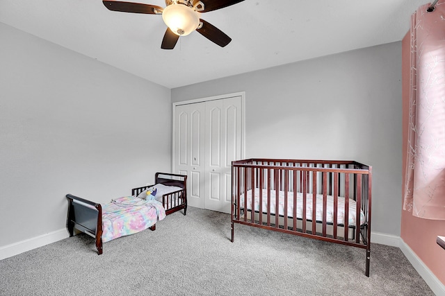 bedroom featuring a ceiling fan, carpet, a closet, and baseboards