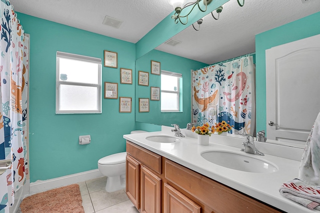 bathroom featuring a wealth of natural light, visible vents, and a sink