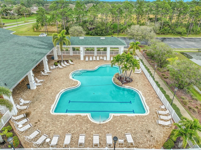 community pool featuring a patio area and fence