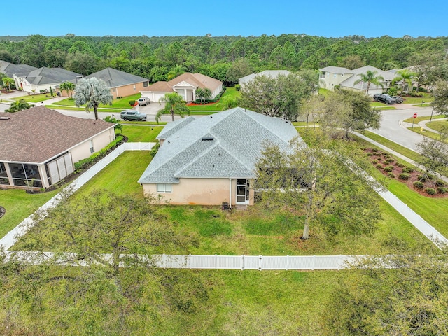 aerial view featuring a forest view and a residential view