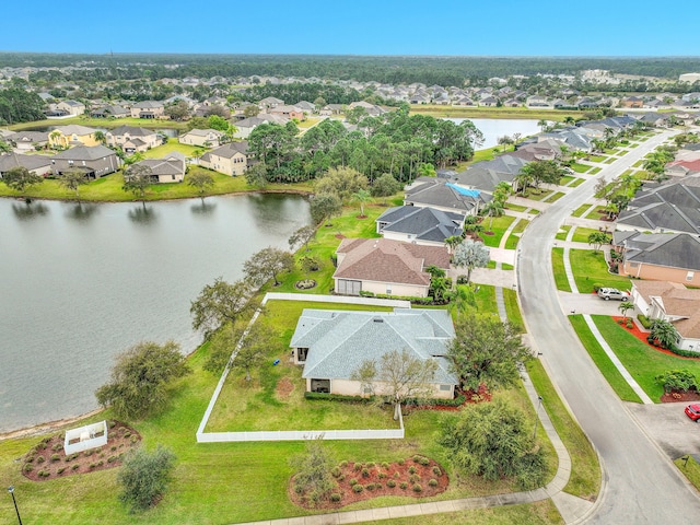 drone / aerial view featuring a water view and a residential view