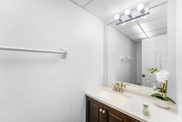 bathroom with vanity and a drop ceiling