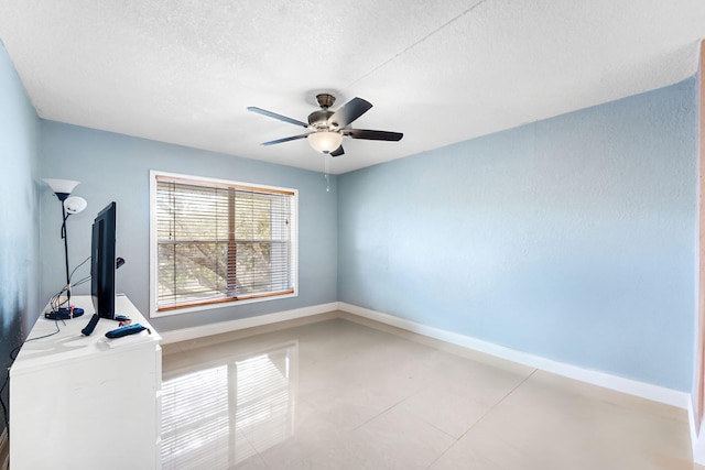 interior space featuring ceiling fan and a textured ceiling