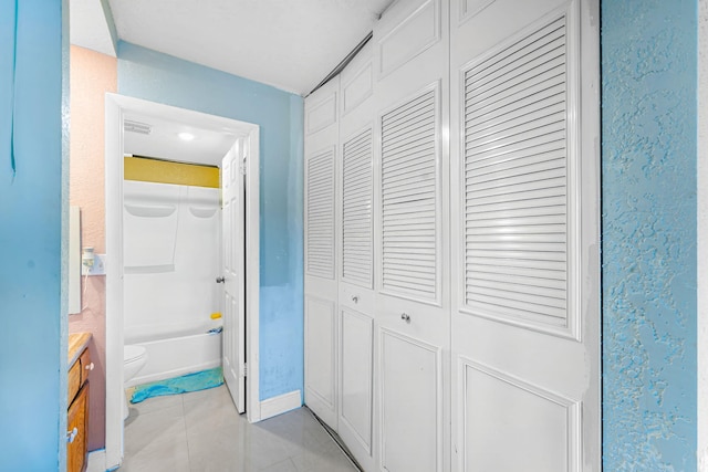 hall featuring light tile patterned flooring