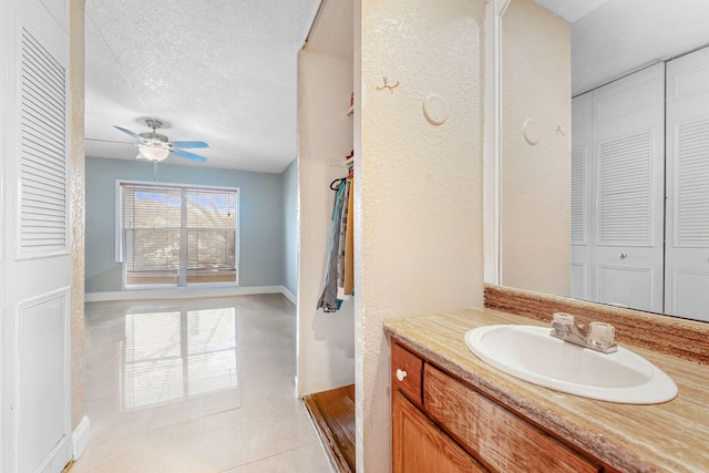 bathroom featuring vanity, ceiling fan, tile patterned floors, and a textured ceiling