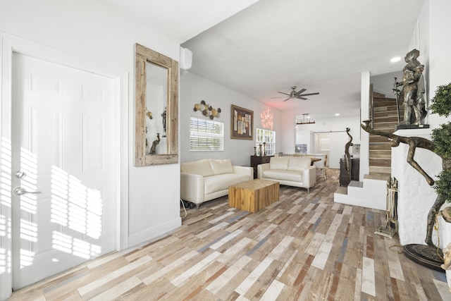 living room featuring light hardwood / wood-style floors and ceiling fan