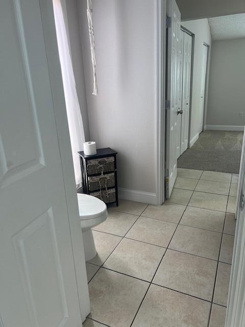 bathroom featuring tile patterned flooring and toilet