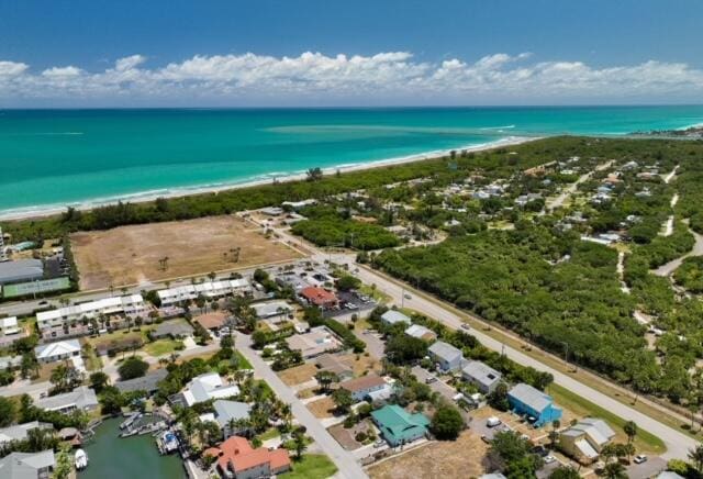 drone / aerial view with a water view and a view of the beach