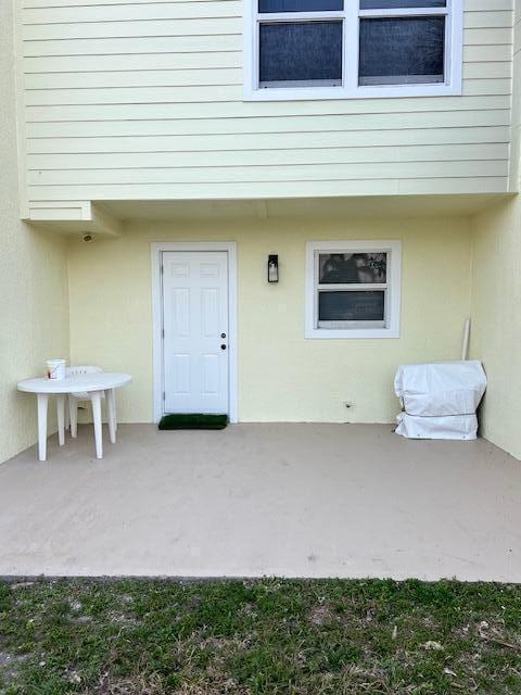 entrance to property featuring a patio area