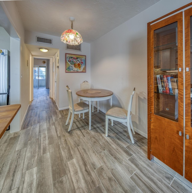 dining space with light hardwood / wood-style flooring