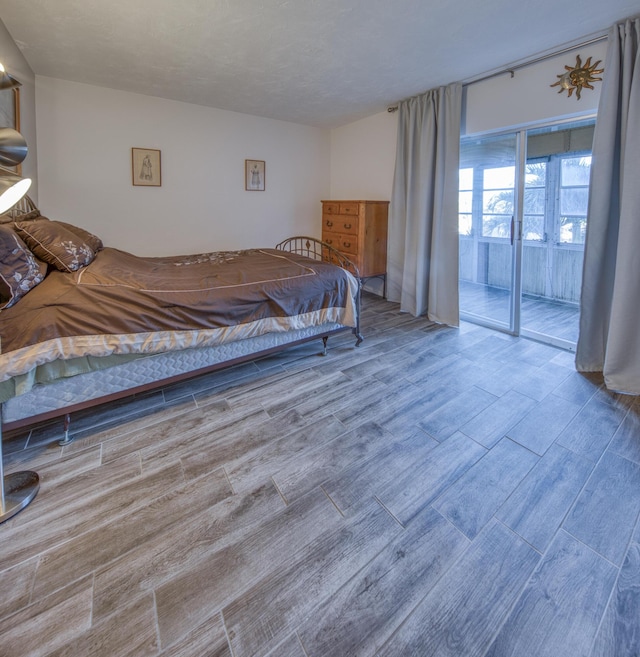 bedroom featuring hardwood / wood-style floors and access to exterior