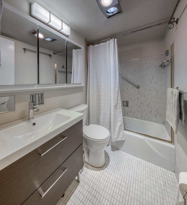 full bathroom featuring vanity, tile patterned floors, toilet, and shower / bath combo with shower curtain