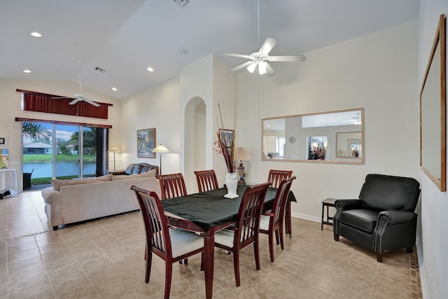 tiled dining room featuring ceiling fan and high vaulted ceiling