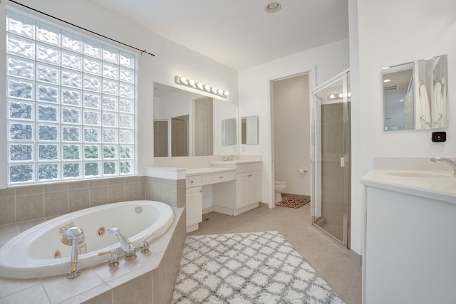 full bathroom featuring vanity, tile patterned floors, toilet, and separate shower and tub