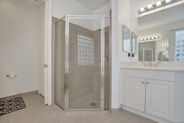 bathroom with vanity, a shower with door, and tile patterned floors