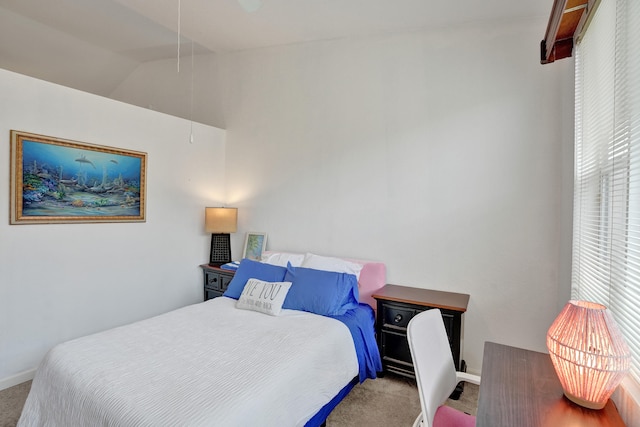 carpeted bedroom featuring lofted ceiling