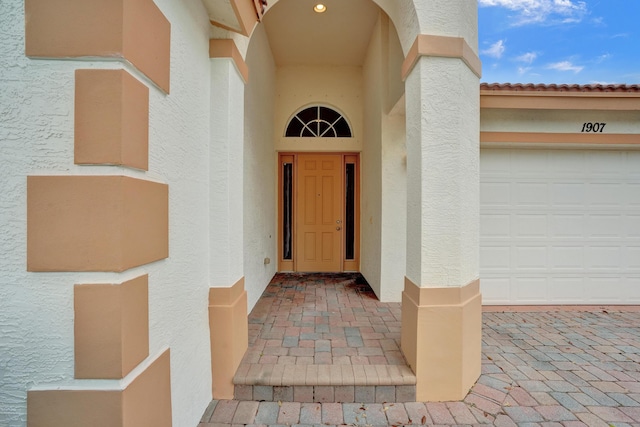 doorway to property with a garage