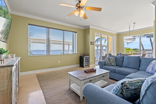 living room with baseboards, ornamental molding, and a wealth of natural light