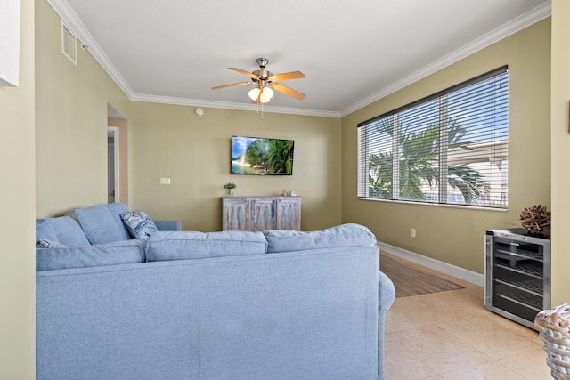 living room with ceiling fan, wine cooler, visible vents, baseboards, and ornamental molding