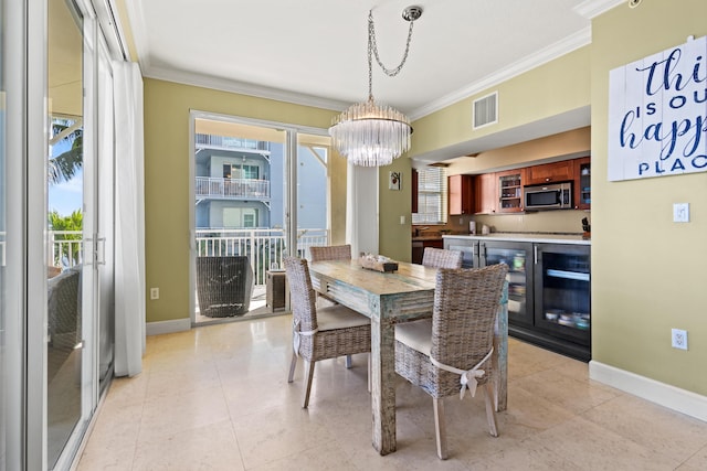 dining area with a chandelier, visible vents, crown molding, and baseboards