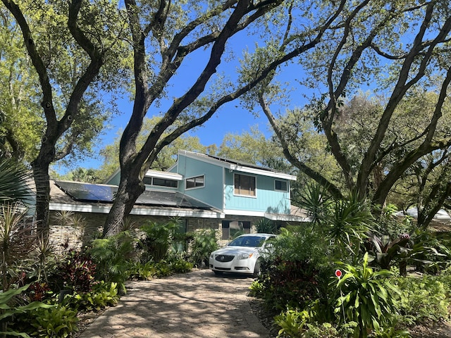 view of front facade featuring solar panels