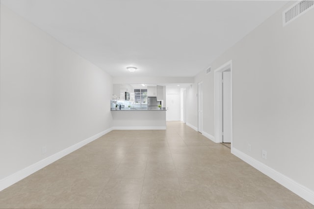 unfurnished living room with light tile patterned flooring