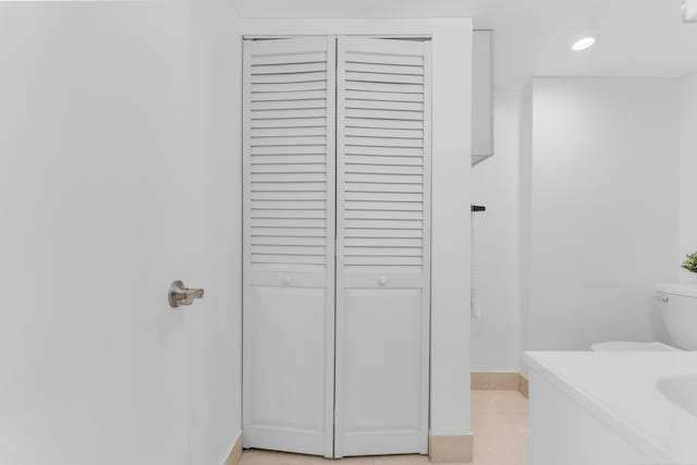 bathroom featuring tile patterned flooring, vanity, and toilet