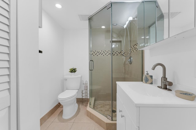 bathroom with vanity, tile patterned floors, toilet, and walk in shower