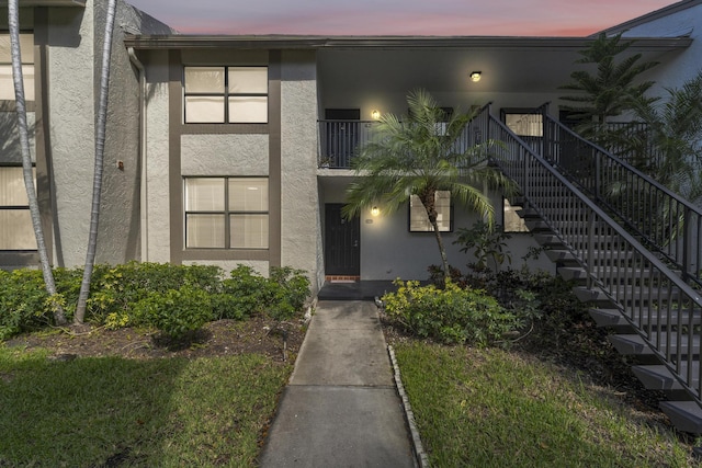 property entrance with stucco siding