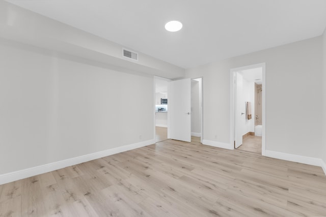 empty room with light hardwood / wood-style floors