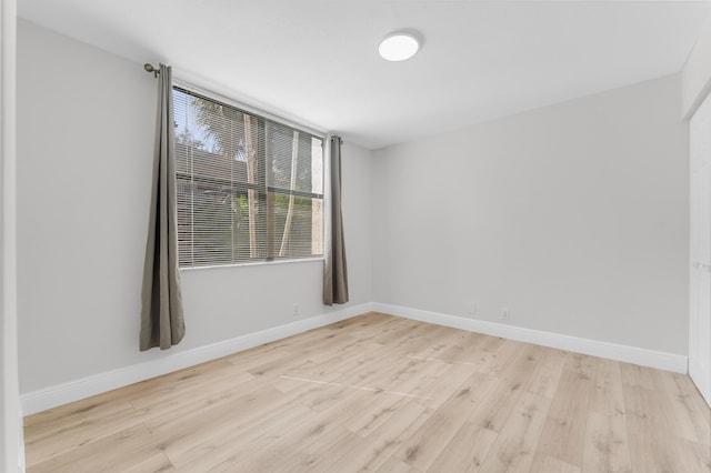 spare room with light hardwood / wood-style flooring