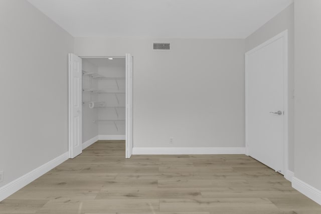 spare room featuring light wood-type flooring