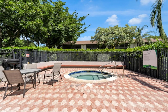 view of swimming pool featuring a hot tub and a patio