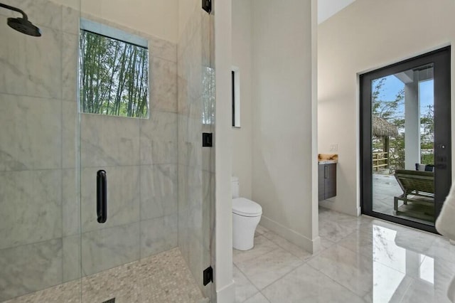 full bathroom featuring baseboards, a shower stall, and toilet