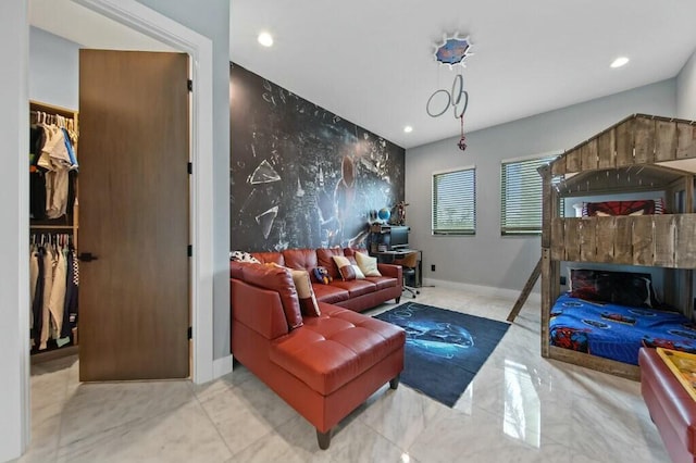 bedroom featuring marble finish floor, a fireplace, recessed lighting, an accent wall, and baseboards