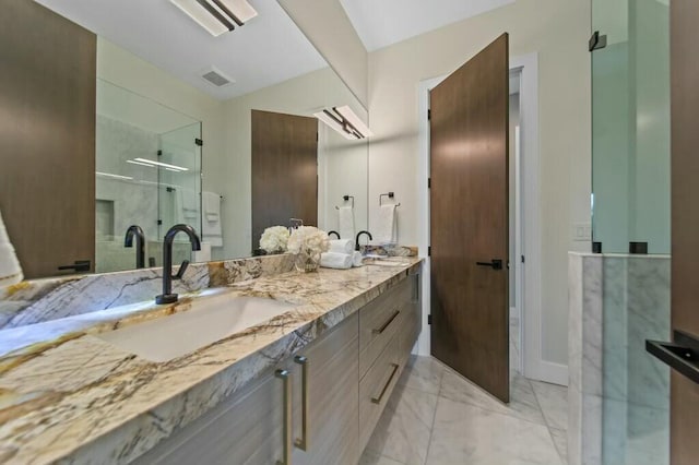 bathroom featuring double vanity, a stall shower, visible vents, marble finish floor, and a sink