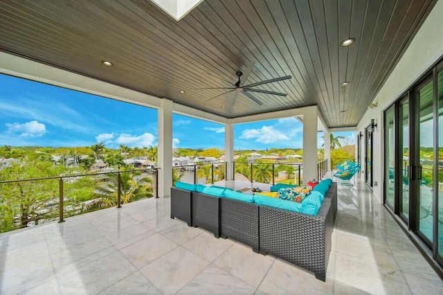 view of patio featuring a balcony, ceiling fan, and an outdoor living space