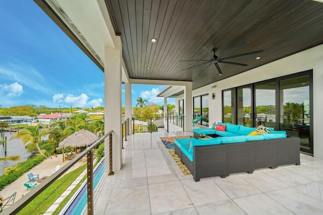 view of patio / terrace with an outdoor living space, ceiling fan, and a balcony